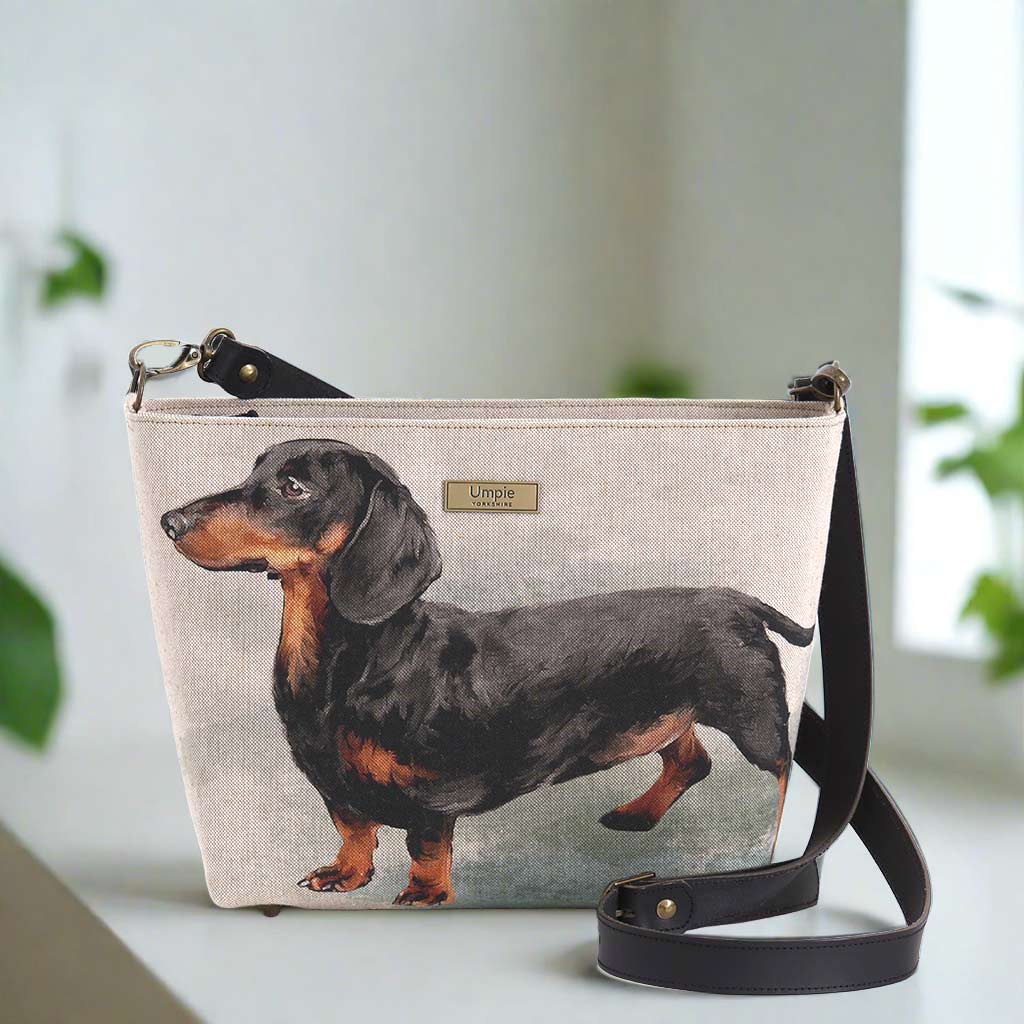 The Dachshund Crossbody Bag with a black leather strap