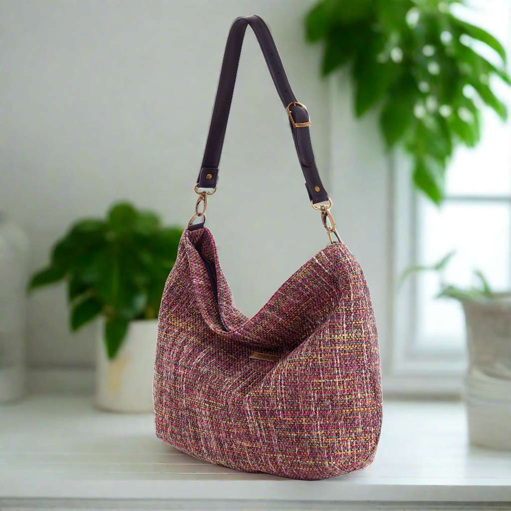 The Pink Tweed Hobo Bag with a black leather strap