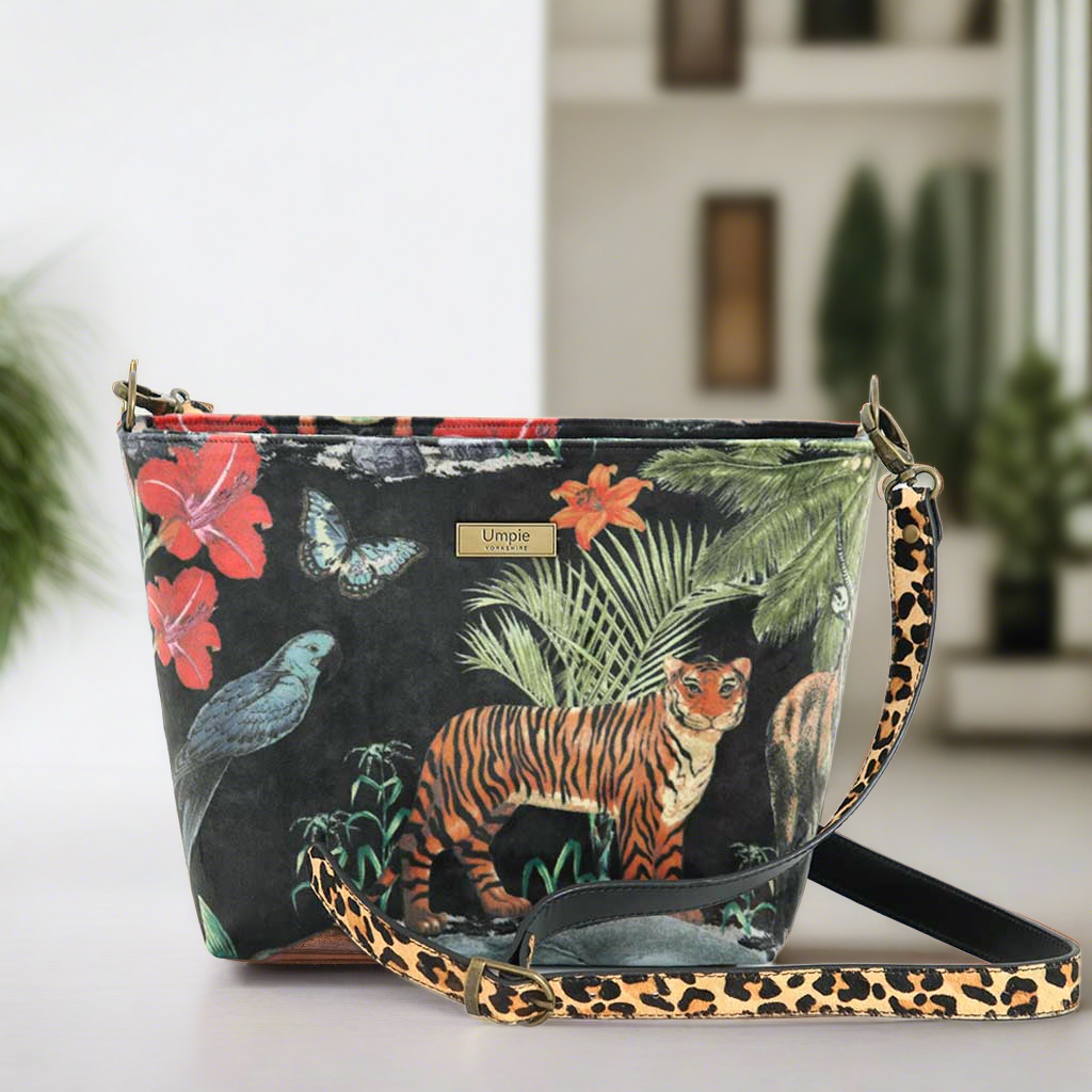 The Velvet Tiger Crossbody Bag with an animal print leather strap