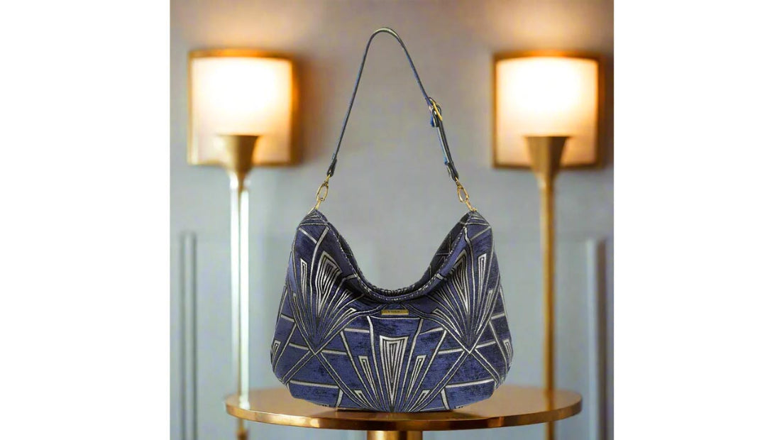 Luxurious Art Deco hobo bag featuring rich 1920s-inspired velvet in deep jewel tones, complemented by a sleek black leather shoulder strap, showcasing premium craftsmanship and vintage-inspired elegance by Umpie Handbags