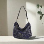 Angled view of Art Deco Hobo Bag displaying elegant hobo silhouette and Art Deco detailing by Umpie Handbags