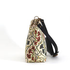 Art Nouveau Crossbody Bag side view showing zip-top closure and black leather strap detail, handmade in Great Britain by Umpie Handbags