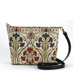 Art Nouveau Crossbody Bag front view — cream woven tapestry with deep navy, burgundy and sage iris florals, black leather strap and antique brass hardware, by Umpie Handbags