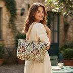 Art Nouveau Shoulder Bag with flowing floral jacquard fabric in rich jewel tones, premium beige leather handles, structured silhouette with metal feet protection, intricate botanical motifs inspired by late 19th century artistic movement, zip-top closure, by Umpie Handbags