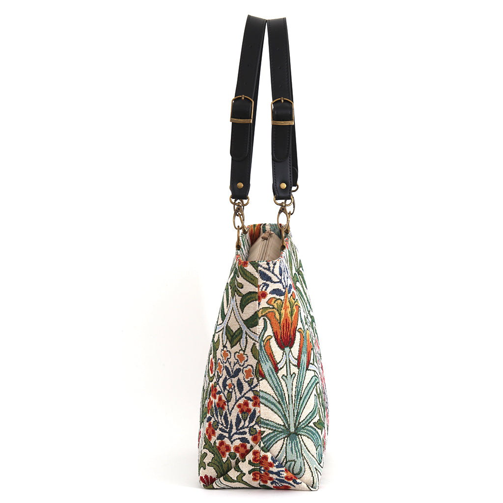 Angled side view of Arts & Crafts Tapestry Tote Bag showing structured silhouette and depth, botanical tapestry fabric with black leather handles, by Umpie Handbags

