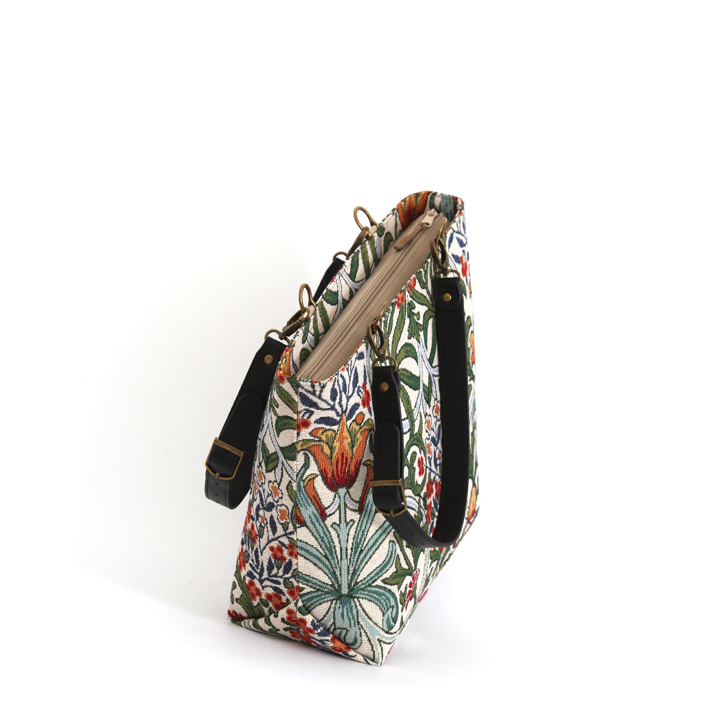 Arts & Crafts botanical tapestry shoulder bag worn over the shoulder, rich floral pattern with black leather straps, handcrafted in Yorkshire by Umpie Handbags