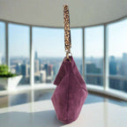 Aubergine velvet hobo bag showcasing plush purple velvet fabric with light-catching sheen, distinctive leopard-print leather strap, spacious curved shape with secure top closure - side profile by Umpie Handbags