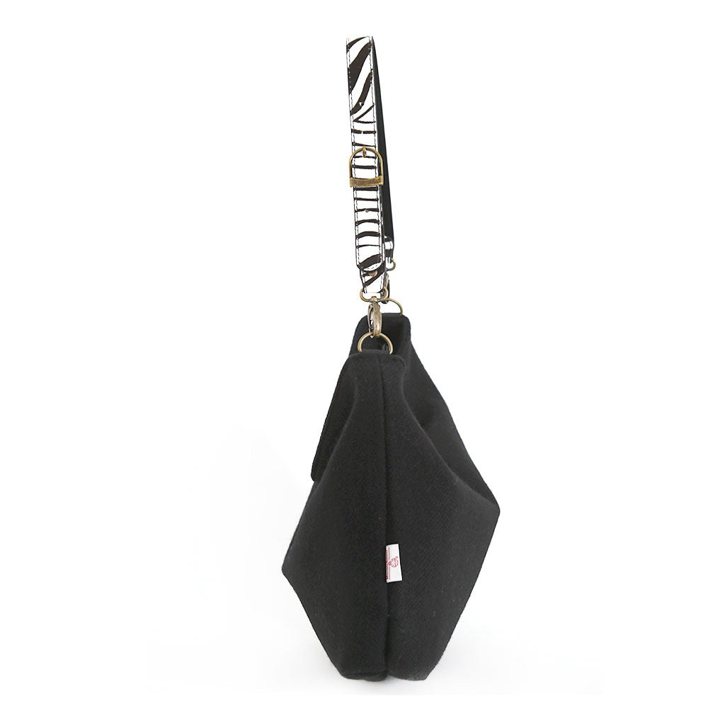 Side view of the Black Harris Tweed Hobo Bag with zebra print leather strap, by Umpie Handbags
