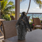 Black lizard print hobo bag resting in a wicker chair showing relaxed slouchy silhouette and textured fabric detail, by Umpie Handbags