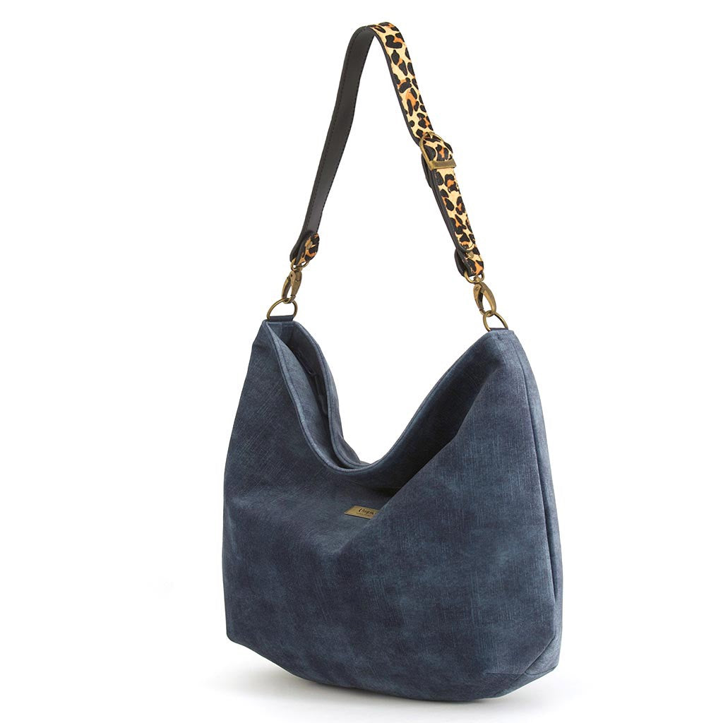 Luxurious blue velvet hobo bag with bold leopard print leather strap, front view showing rich texture and slouchy silhouette by Umpie Handbags