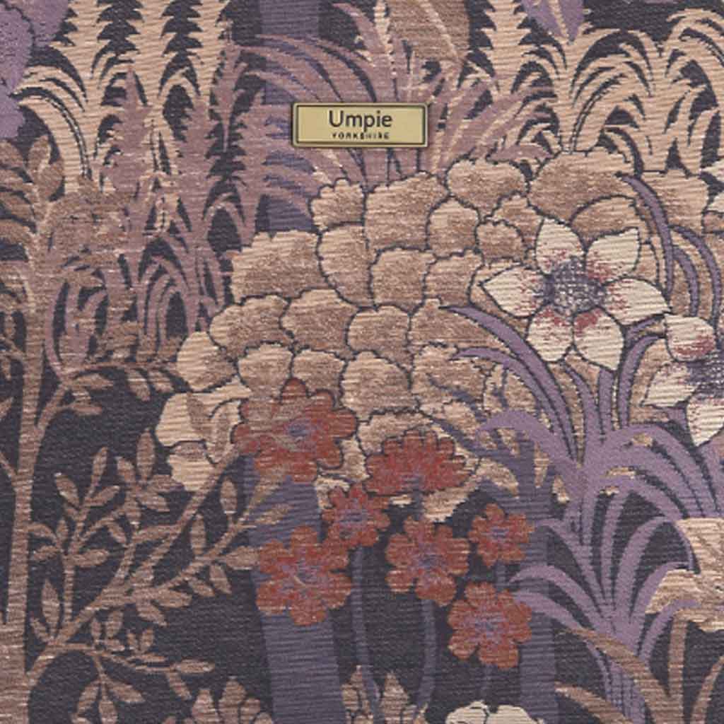 Close-up of purple brocade fabric showing intricate metallic floral pattern and sumptuous texture by Umpie Handbags