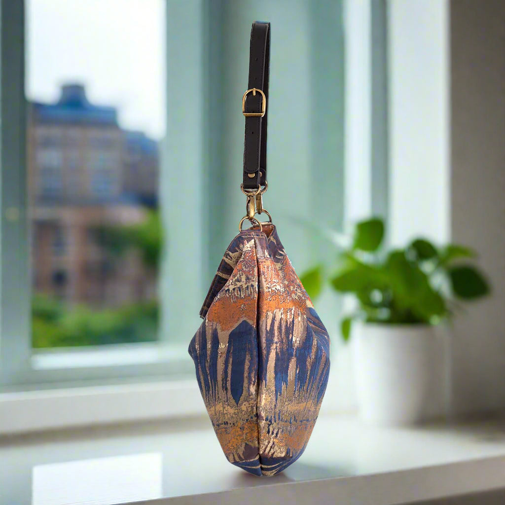 Bronze metallic hobo bag side profile showing spacious design and adjustable leather strap