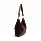 Side view of the brown velvet hobo bag showing the generous slouchy silhouette and matching leopard print strap by Umpie Handbags