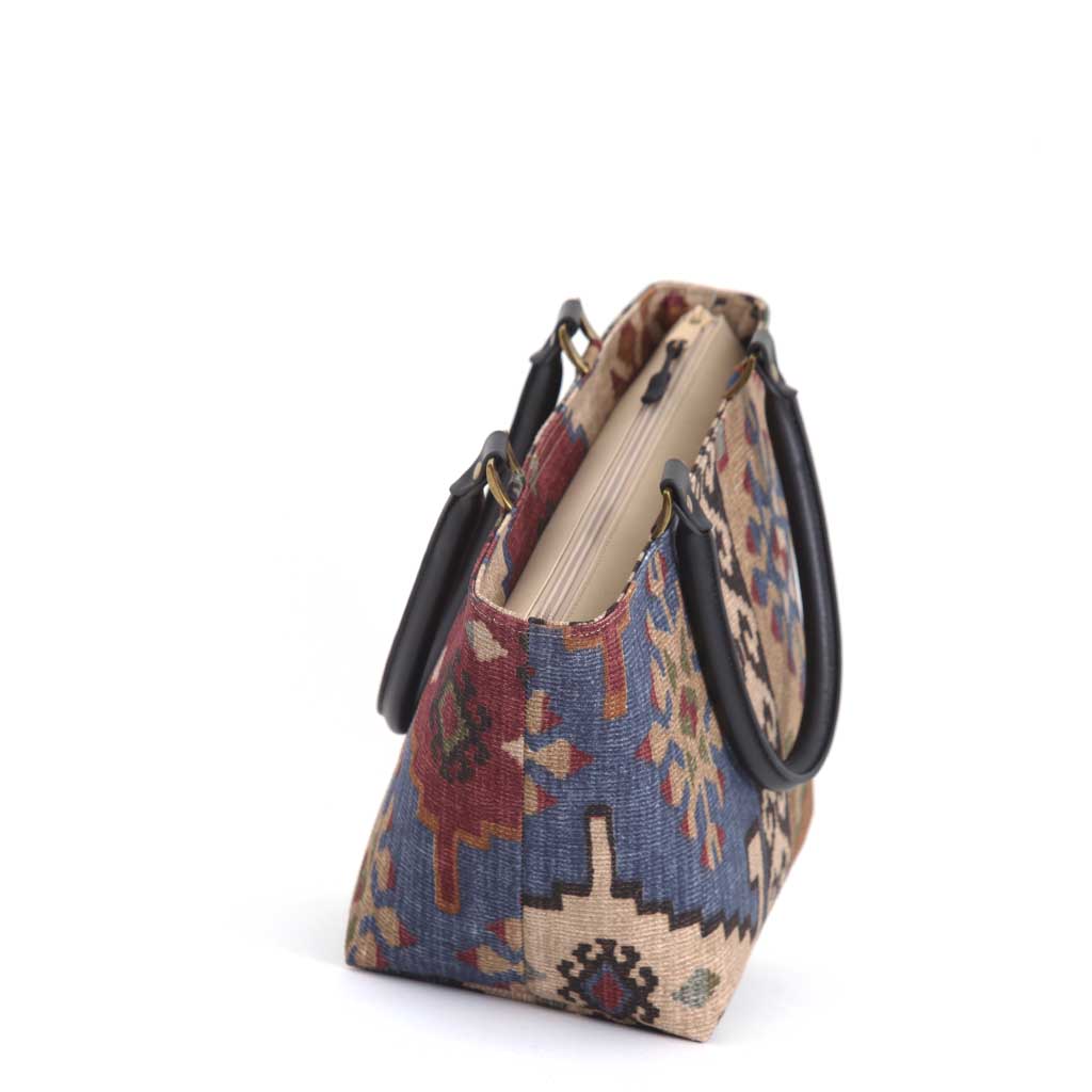 Top-down view revealing secure zip closure with quality hardware, black leather handle attachment detail, spacious interior opening, and heritage Kilim pattern canvas construction handcrafted in Yorkshire by Umpie Handbags