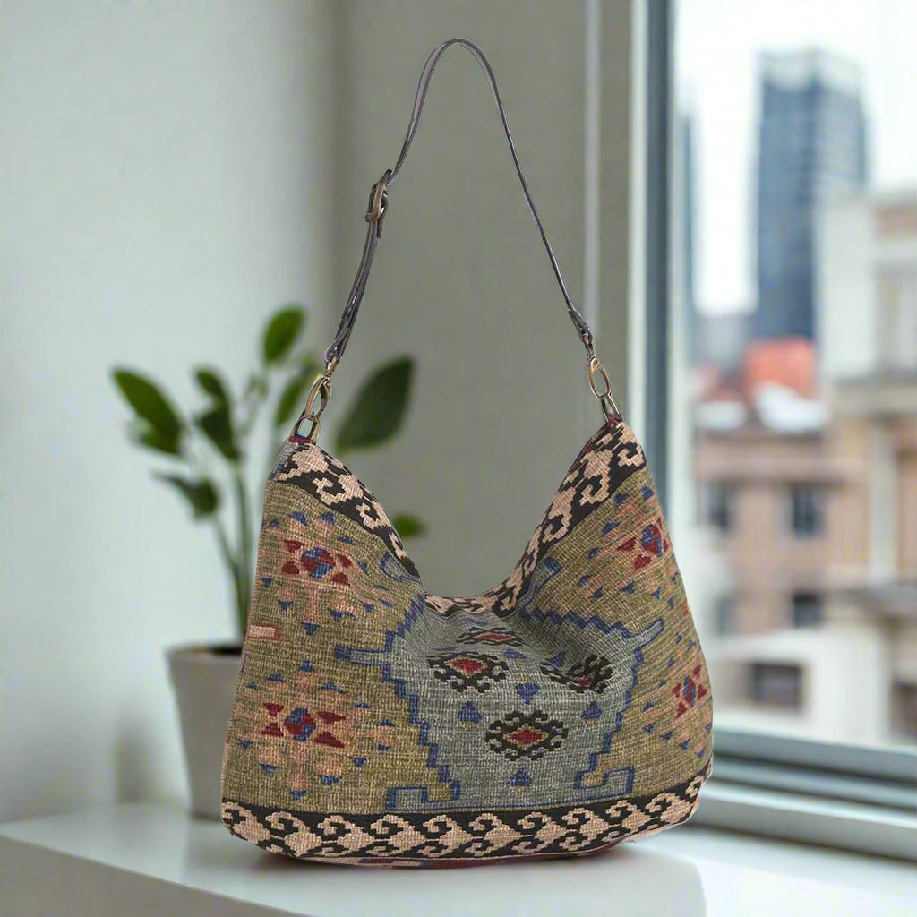 The Canvas Hobo Bag, Kilim design with a brown leather strap - back view.