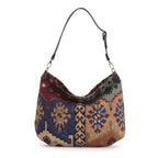 The front view of the Artisan Kilim Canvas Hobo Bag with a black leather strap, by Umpie Handbags