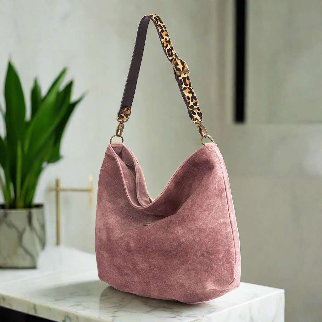 The Dustry Pink Velvet Hobo Bag with a leopard print leather strap.
