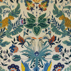 Decorative fabric pattern lining with leopards, butterflies, and floral elements on a beige background.