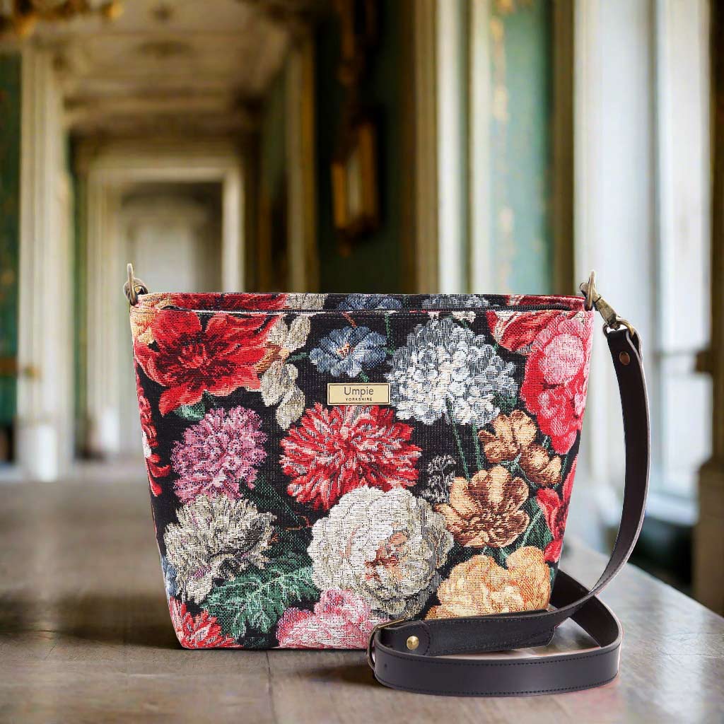 The Floral Tapestry Crossbody Bag with a black leather strap