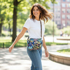 Model carrying vibrant floral crossbody bag featuring tropical botanical print in lush greens and coral tones with adjustable leopard print leather strap, showcasing hands-free everyday styling and sustainable eco-friendly fabric by Umpie Handbags