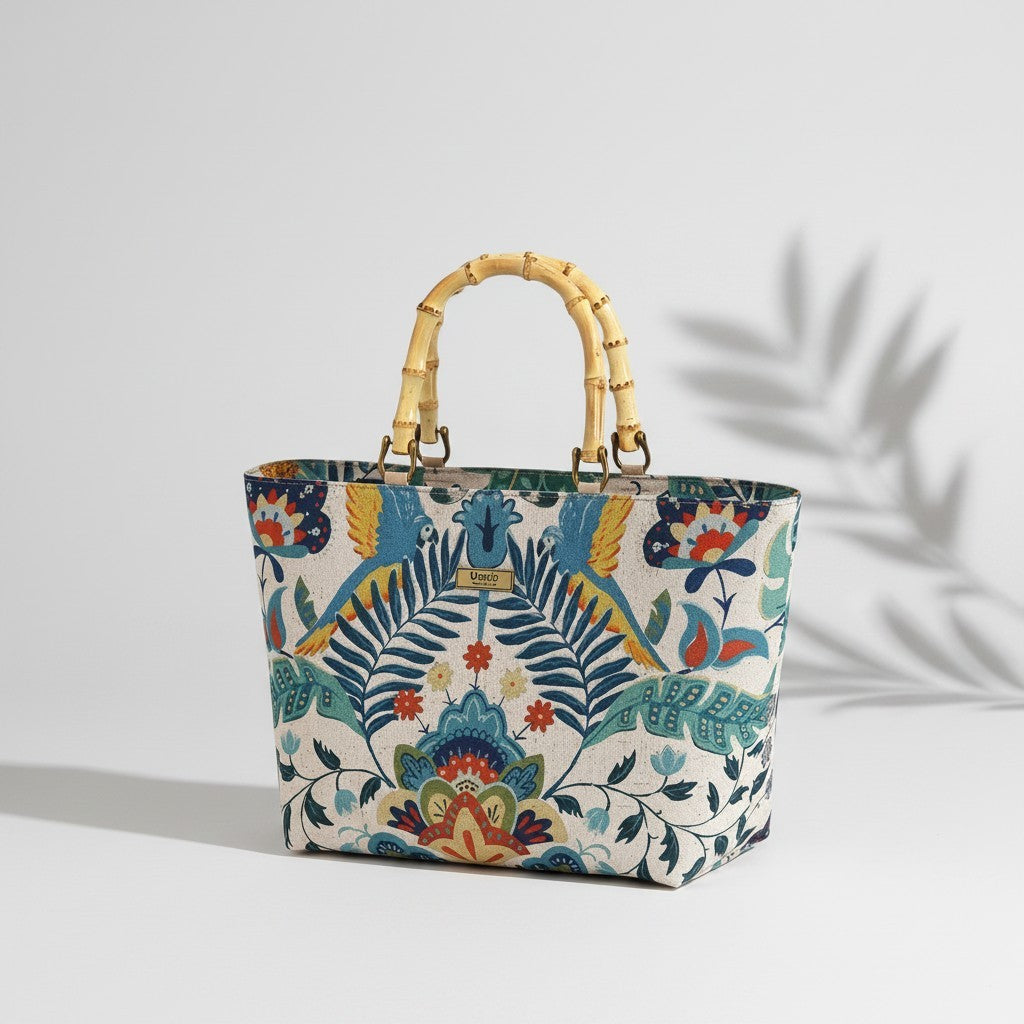 Front view of a floral linen handbag with bamboo handles standing upright showcasing the full botanical floral print and the warm natural curve of the bamboo handles, by Umpie Handbags