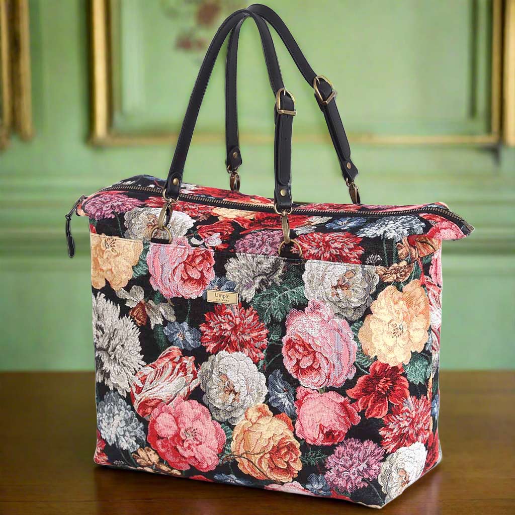 The Floral Tapestry Weekend Bag with black leather straps.