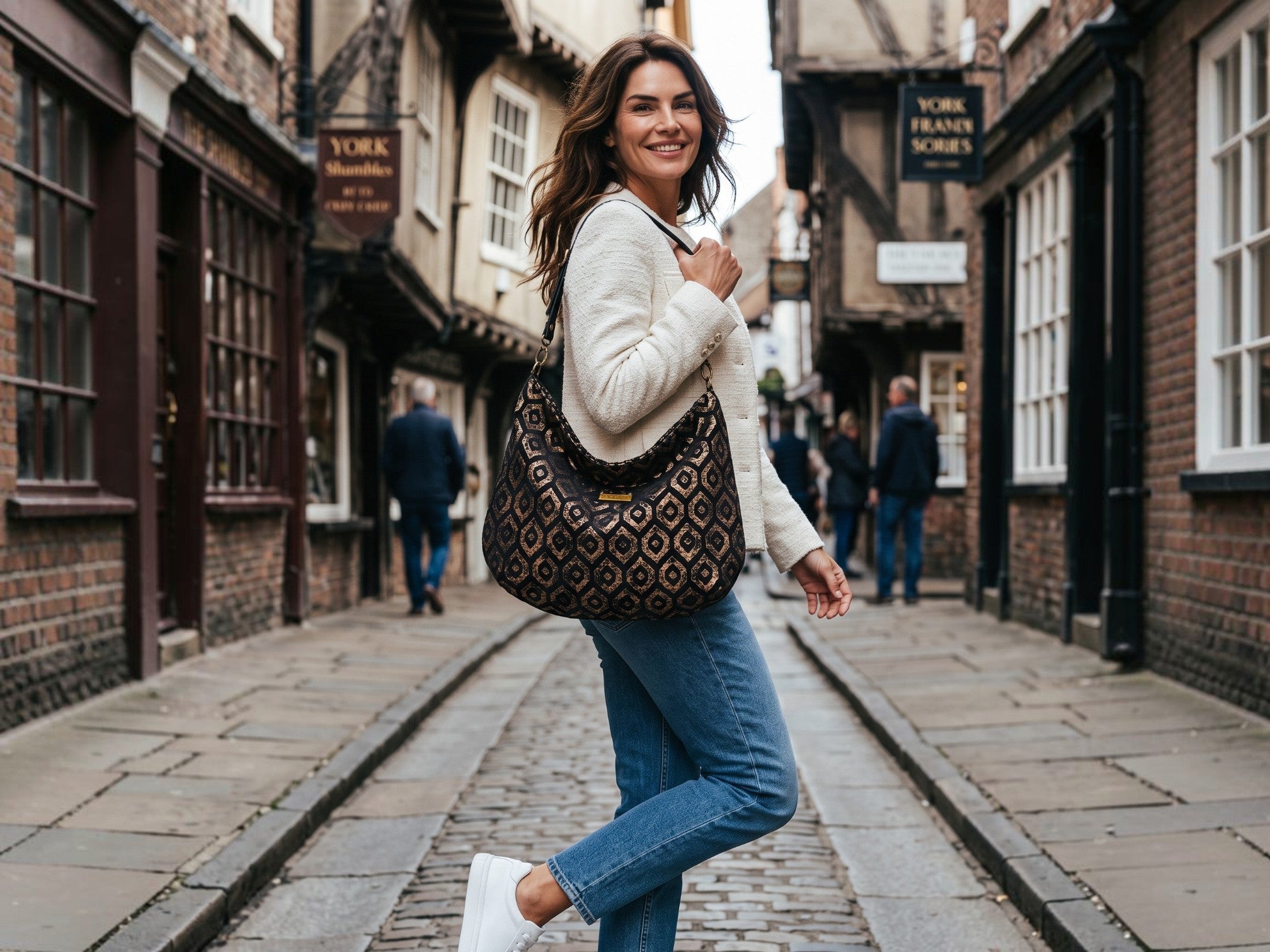 woman walking in York holding the Gold Metallic Hobo Bag by Umpie Handbags