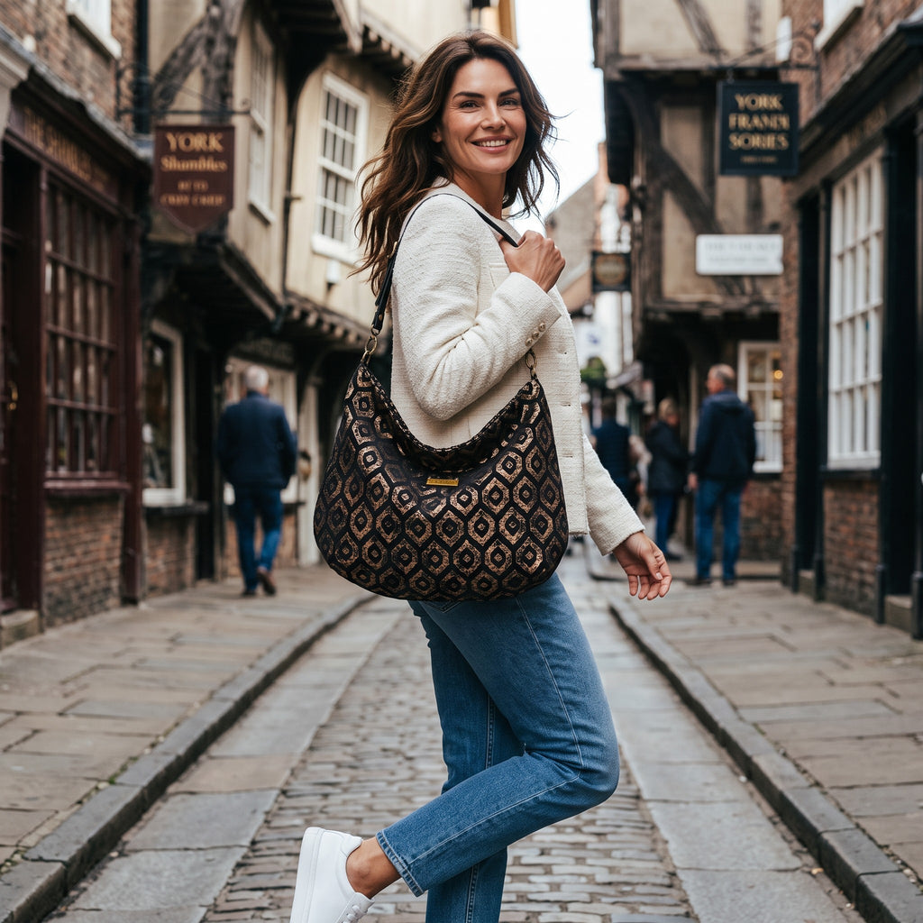 Luxurious gold metallic hobo bag with shimmering champagne finish, relaxed slouchy silhouette, premium black leather shoulder strap and quality hardware by Umpie Handbags