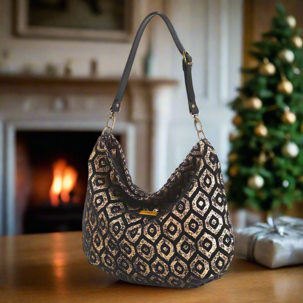 Gold Metallic Hobo Bag with a black leather strap.