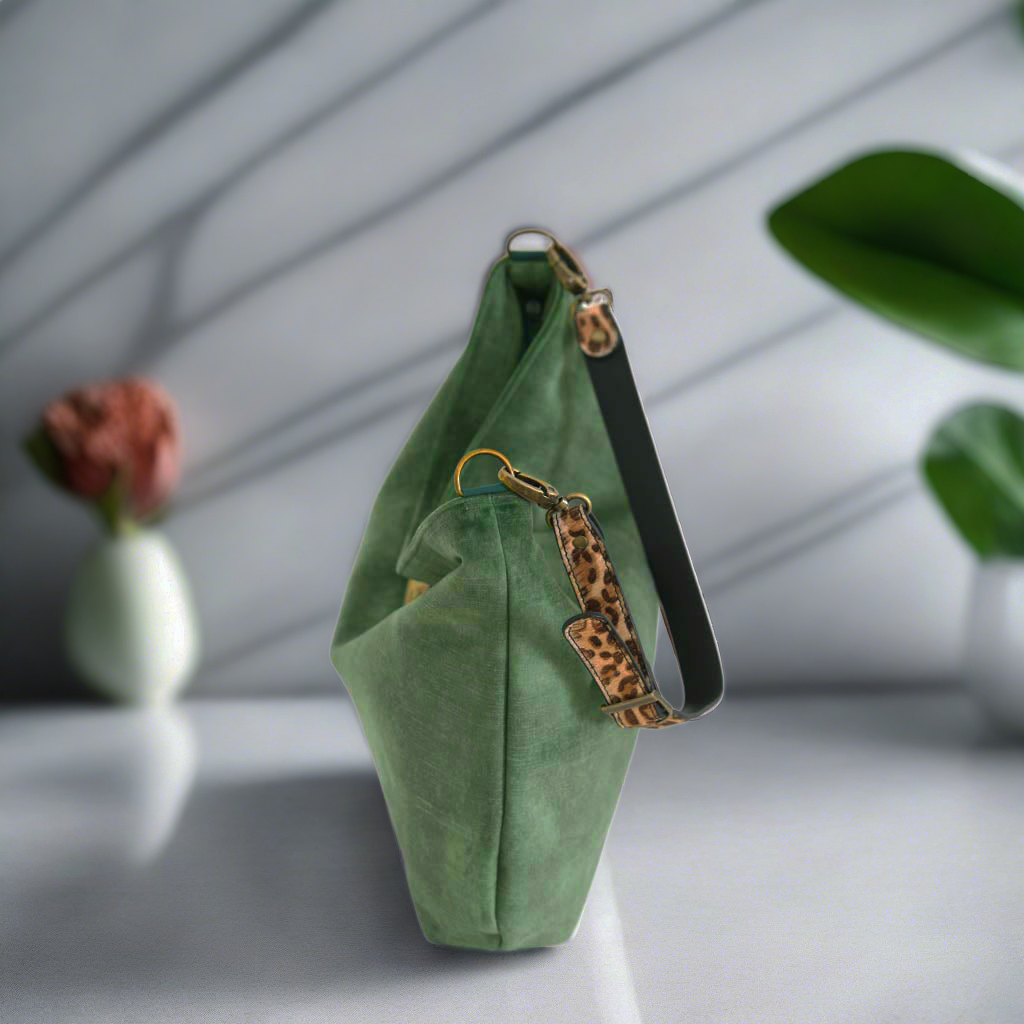 Green velvet hobo bag showing spacious zip-top opening with leopard print leather strap and premium craftsmanship details by Umpie Handbags