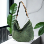 Sumptuous green velvet hobo bag featuring striking leopard print leather strap, soft slouchy silhouette, and British handcrafted quality by Umpie Handbags