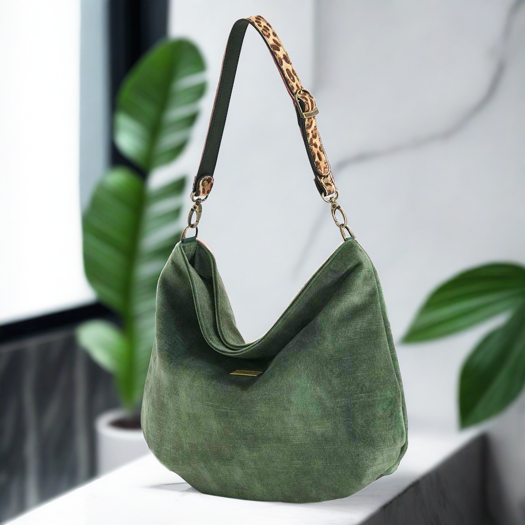 Sumptuous green velvet hobo bag featuring striking leopard print leather strap, soft slouchy silhouette, and British handcrafted quality by Umpie Handbags