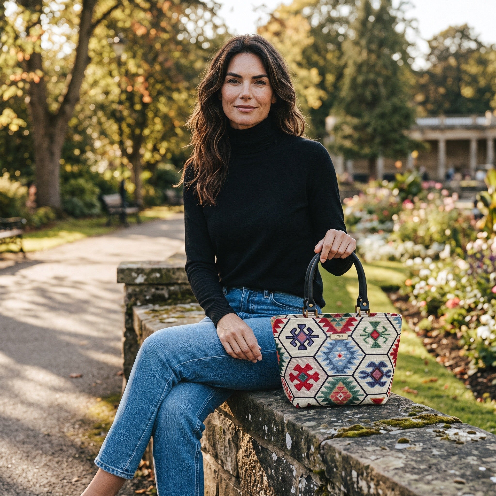 Model seated in the Valley Gardens in Harrogate with the Hexagon Handbag by Umpie Handbags.