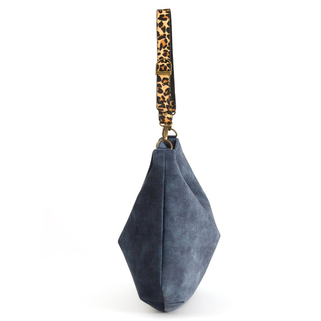 Luxurious blue velvet hobo bag with bold leopard print leather strap, side view showing rich texture and slouchy silhouette by Umpie Handbags