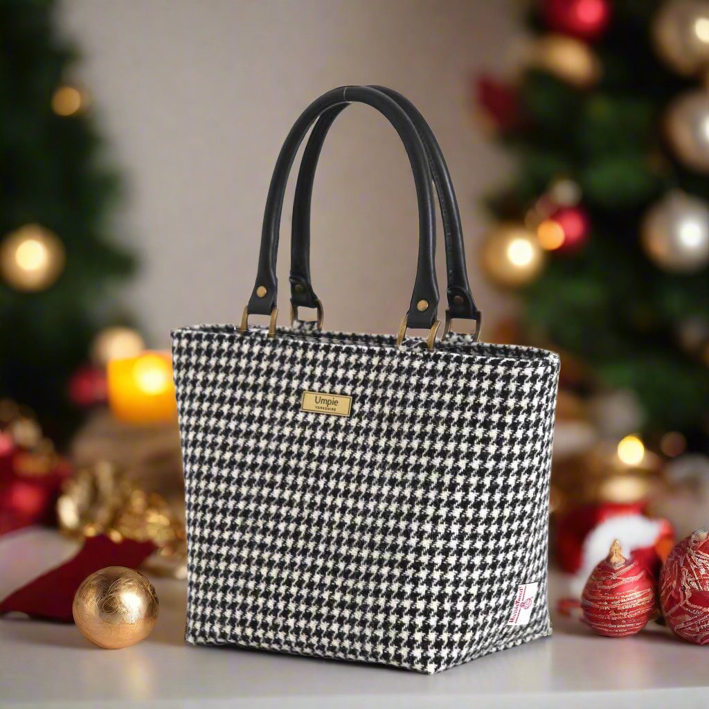 Classic black and white houndstooth Harris Tweed handbag with rich textured Harris Tweed wool fabric, supple black leather handles, and timeless geometric pattern - handcrafted British luxury by Umpie Handbags