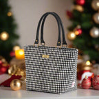Classic black and white houndstooth Harris Tweed handbag with rich textured Harris Tweed wool fabric, supple black leather handles, and timeless geometric pattern - handcrafted British luxury by Umpie Handbags