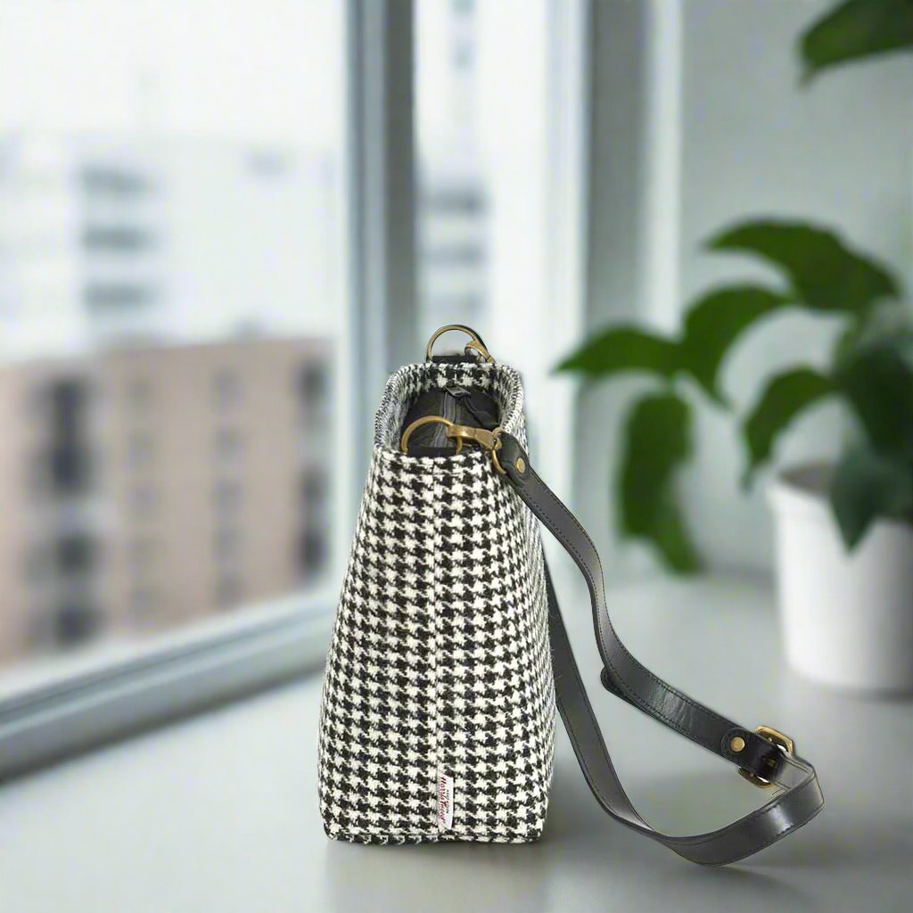 The Houndstooth Crossbody Bag with a black leather strap - side view