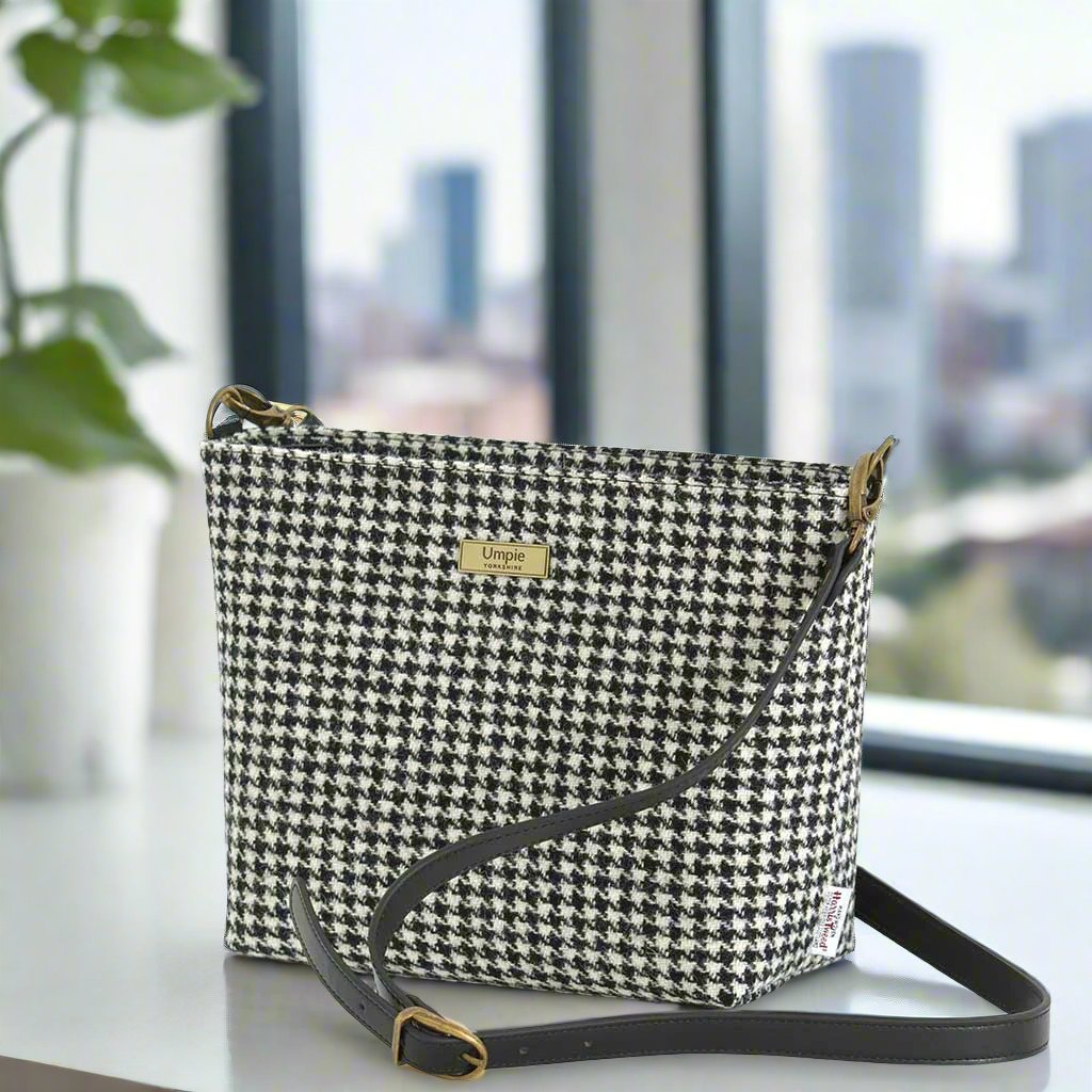 The Houndstooth Crossbody Bag with a black leather strap