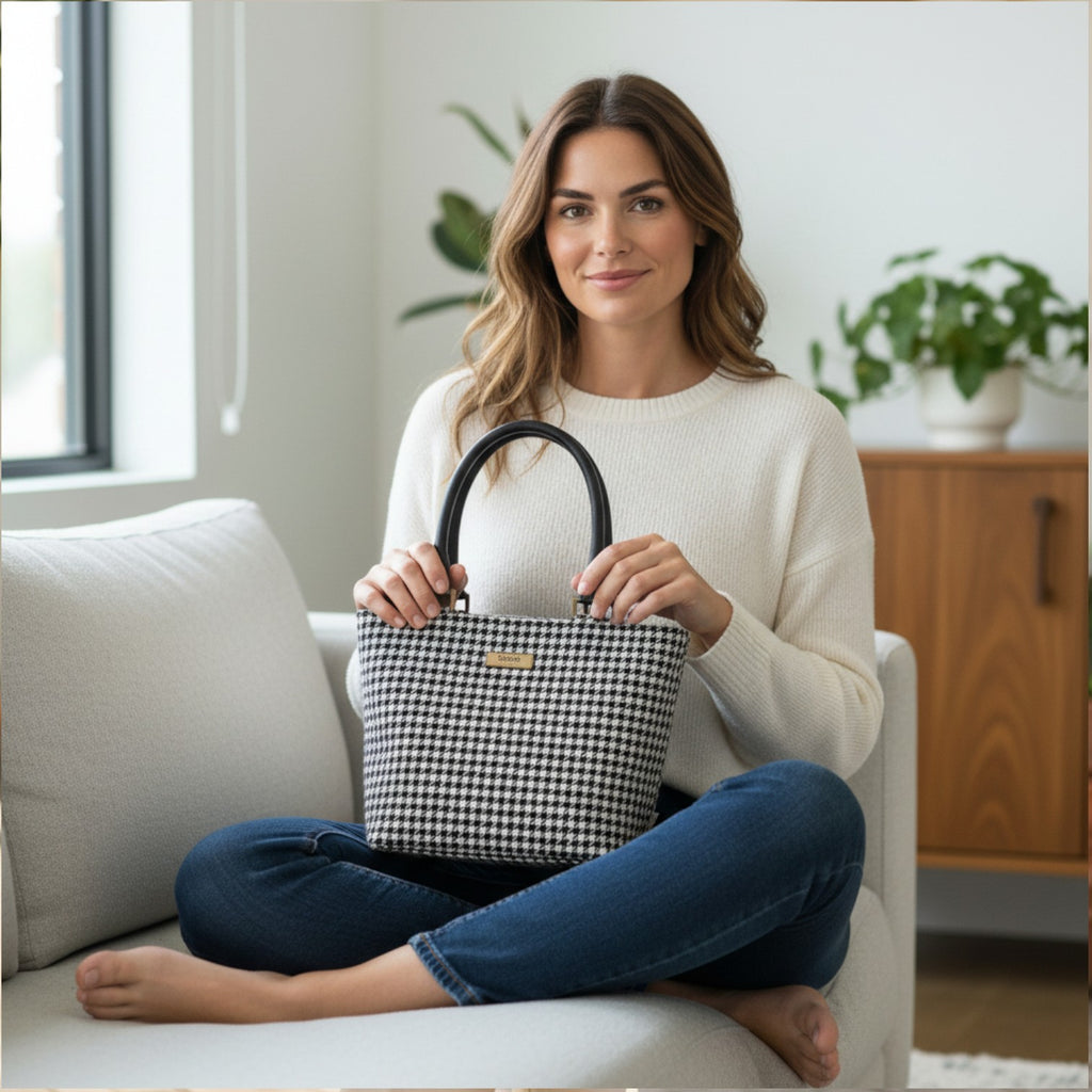 Classic black and white houndstooth Harris Tweed handbag with rich textured wool fabric, supple black leather handles, structured silhouette, authentic Scottish heritage weave, timeless houndstooth pattern, premium craft manship by Umpie Handbags