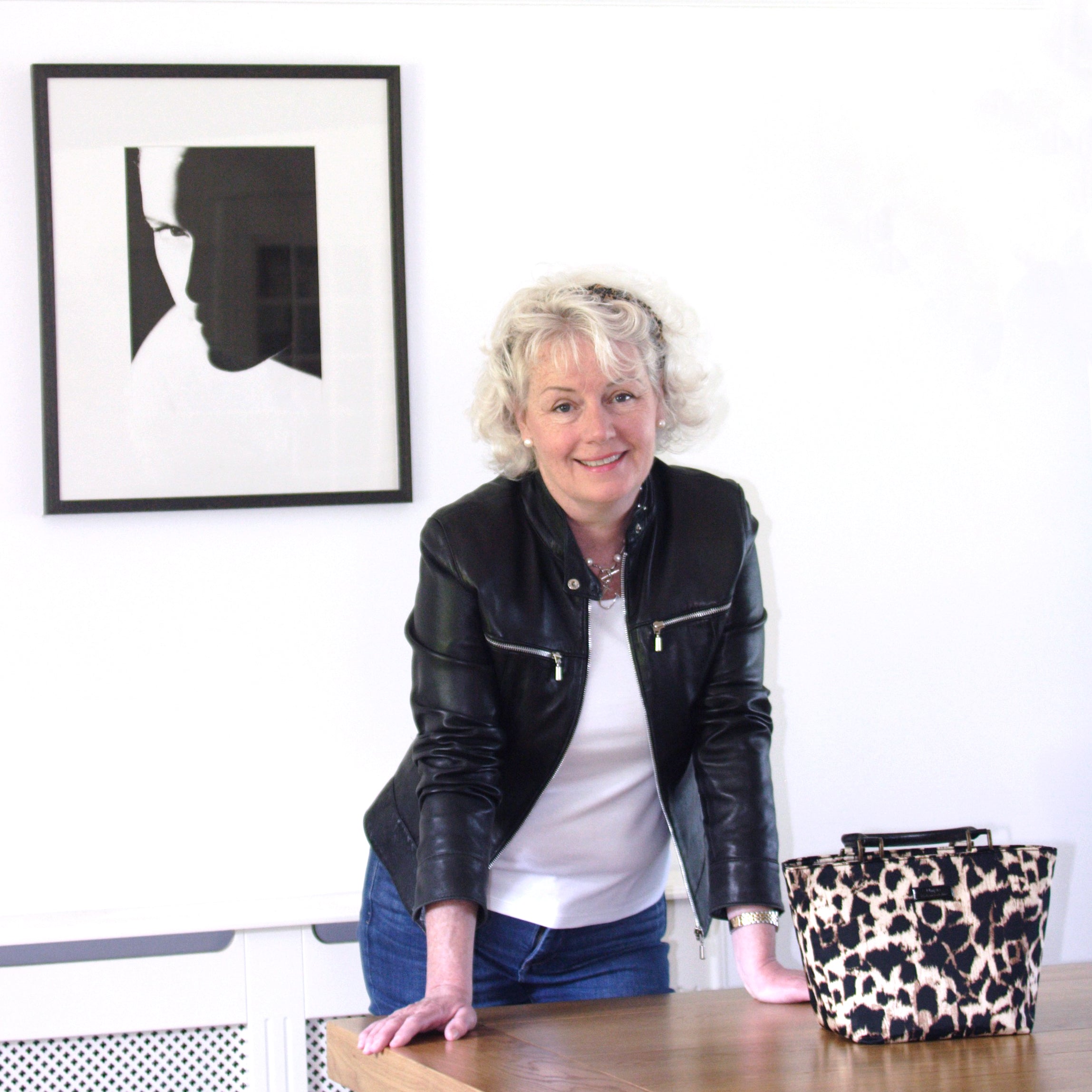 Joanna Umpleby, maker of Umpie Handbags, standing alongside one of her handcrafted animal print bags — individually made by her own hands in her Yorkshire studio, by Umpie Handbags.

