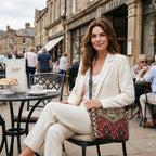Model outside Betty's with the Kilim canvas crossbody bag, rich geometric Kilim pattern in green and wine, handmade in Great Britain by Umpie Handbags