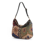 Kilim Canvas Hobo Bag worn over shoulder showing green mix geometric patterns and relaxed silhouette by Umpie Handbags