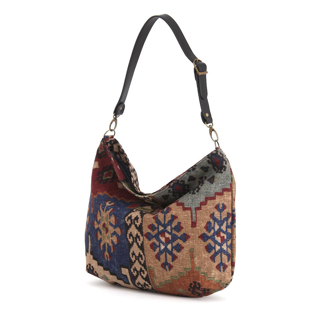Kilim Canvas Hobo Bag worn over shoulder showing navy mix geometric patterns and relaxed silhouette by Umpie Handbags