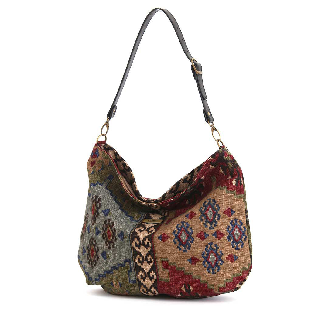 Kilim Canvas Hobo Bag worn over shoulder showing taupe mix geometric patterns and relaxed silhouette by Umpie Handbags