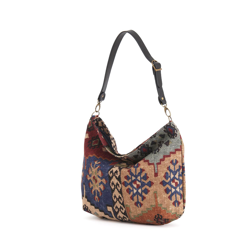 Kilim Canvas Hobo Bag worn over shoulder showing navy mix geometric patterns and relaxed silhouette by Umpie Handbags