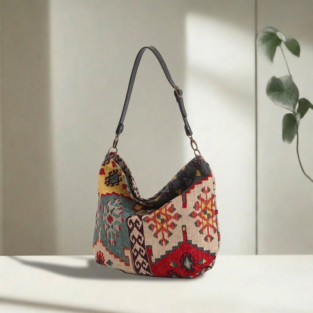 Kilim Canvas Hobo Bag worn over shoulder showing red mix geometric patterns and relaxed silhouette by Umpie Handbags