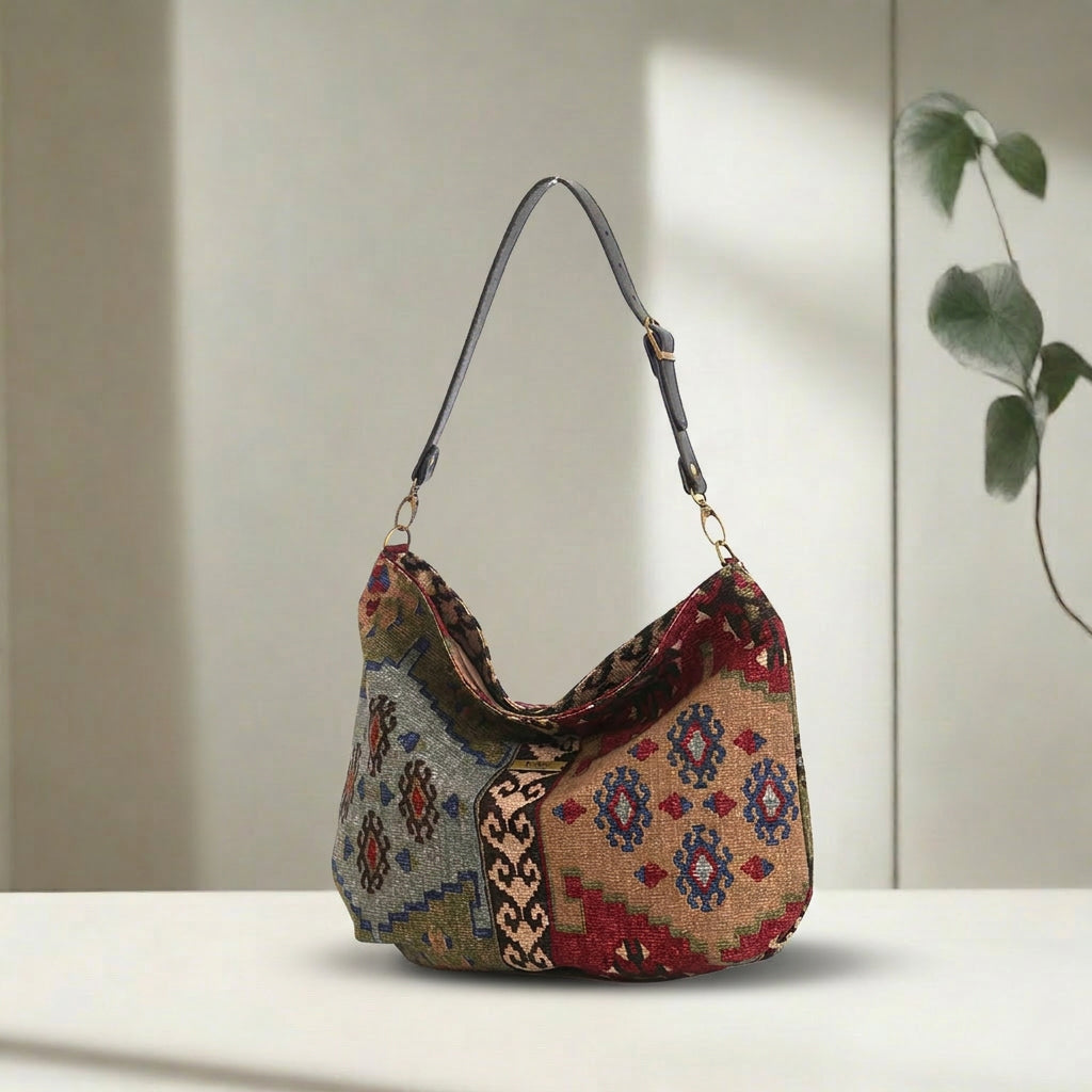 Kilim Canvas Hobo Bag worn over shoulder showing taupe mix geometric patterns and relaxed silhouette by Umpie Handbags