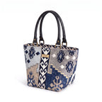 Navy canvas handbag with traditional Kilim geometric pattern in navy, grey, light blue and taupe, black leather handles, front view by Umpie Handbags