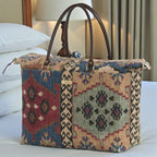 The Canvas Weekend Bag, Kilim Design. Showcasing multicoloured, authentic kilim print with brown leather handles. Handcrafted in Yorkshire by Umpie Handbags