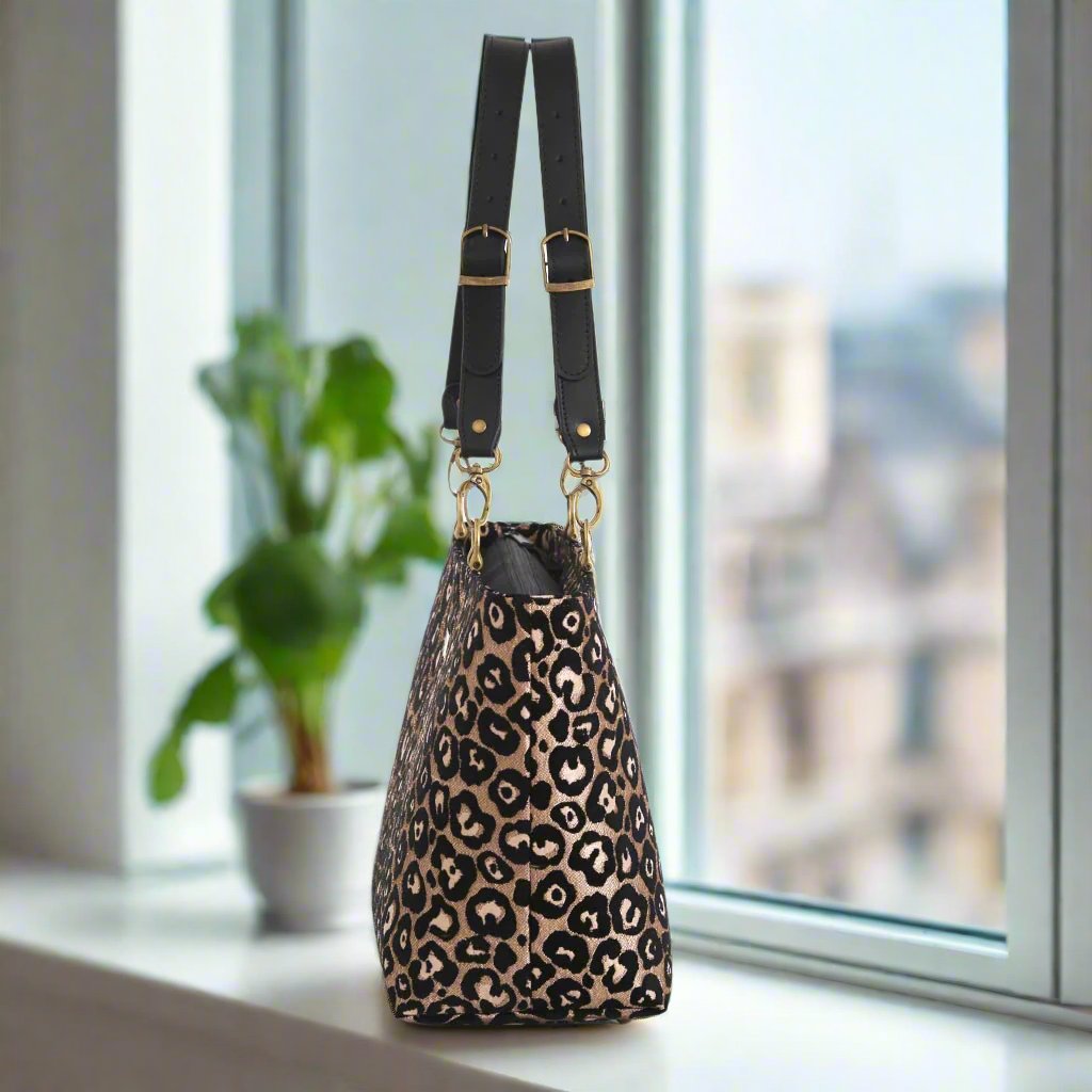 Leopard print shoulder bag with black leather straps - side view